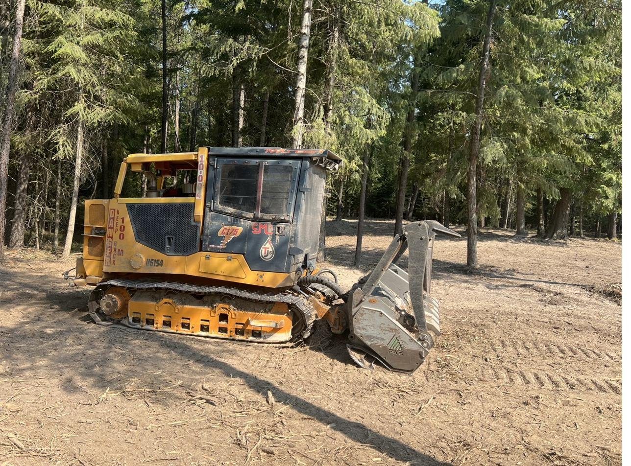Tracked forest masticator with mulcher head in North Idaho