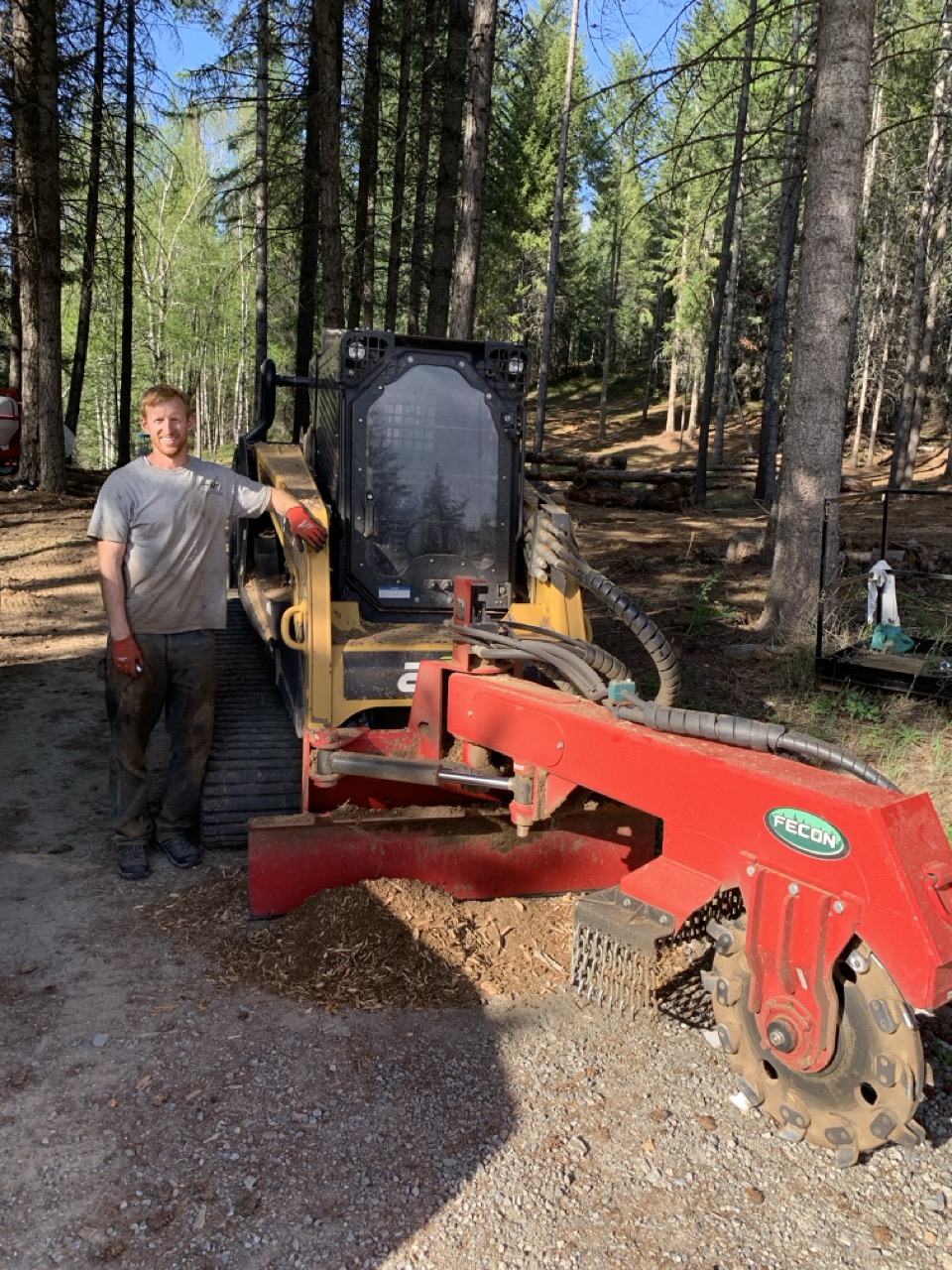 Tom Schneider with the ASV skid steer and Fecon attachment on a North Idaho job